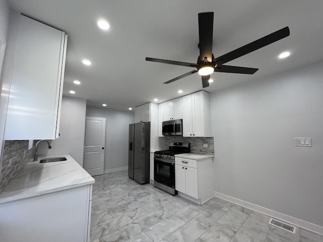 kitchen with visible vents, marble finish floor, a sink, stainless steel appliances, and white cabinets