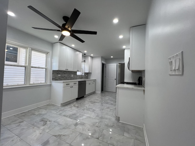 kitchen featuring backsplash, dishwasher, light countertops, white cabinets, and a sink