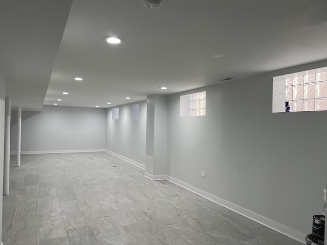 below grade area featuring visible vents, recessed lighting, and baseboards