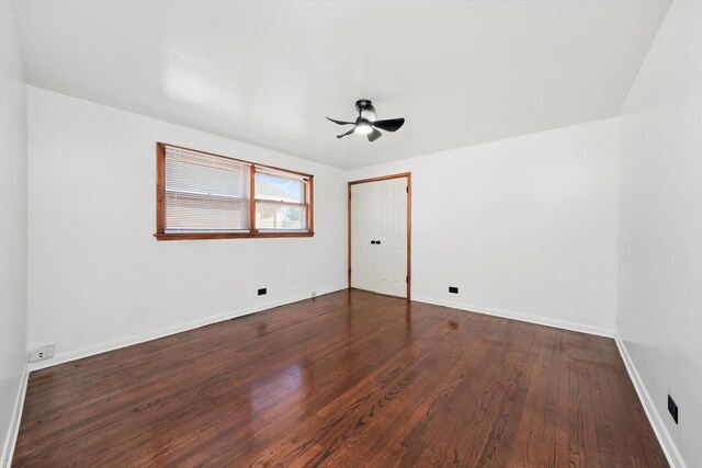 unfurnished room featuring baseboards, wood finished floors, and a ceiling fan