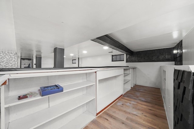 walk in closet with light wood-style floors