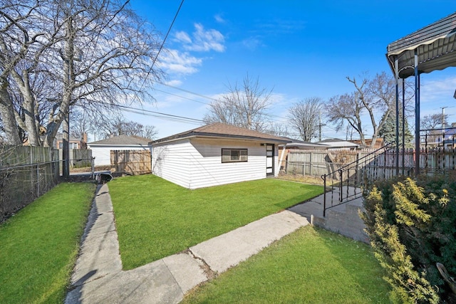 view of yard featuring an outbuilding and a fenced backyard