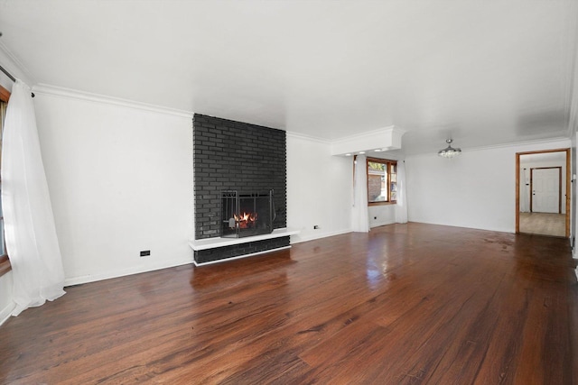 unfurnished living room with wood finished floors, a fireplace, and ornamental molding