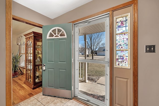 foyer entrance with light tile patterned floors