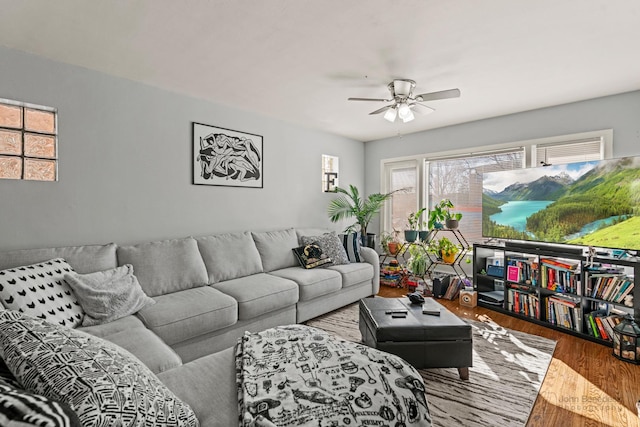 living area with ceiling fan and wood finished floors