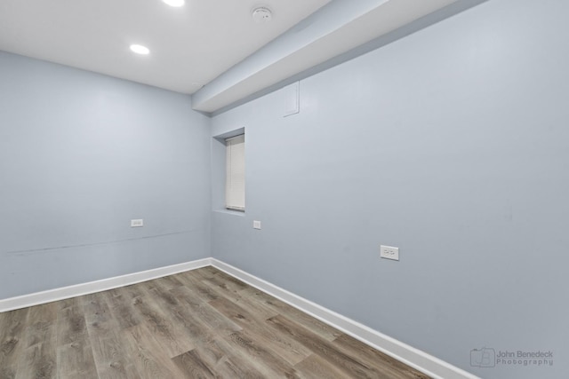 unfurnished room featuring recessed lighting, wood finished floors, and baseboards