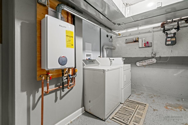 washroom featuring tankless water heater, separate washer and dryer, and concrete block wall