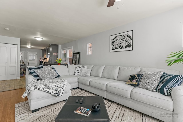 living area with ceiling fan and wood finished floors