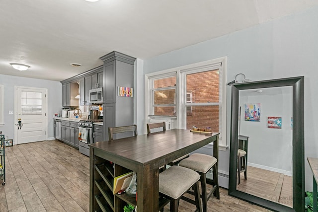 dining room with light wood finished floors and baseboards