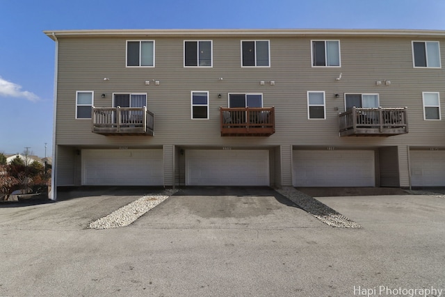 back of property featuring a garage and driveway