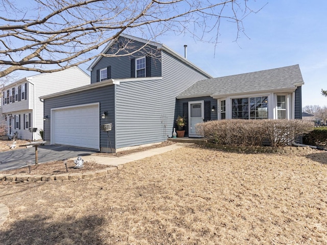 view of front of property with aphalt driveway and a garage