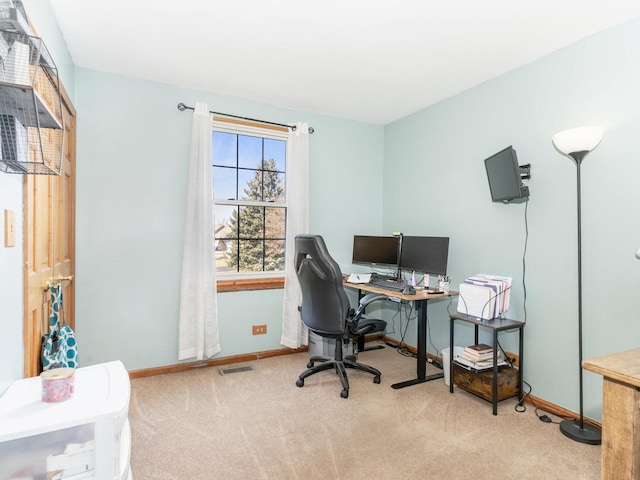 carpeted office with visible vents and baseboards