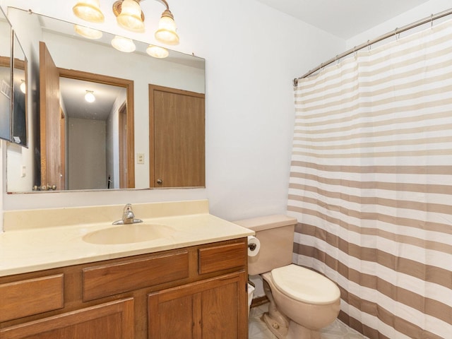 bathroom featuring toilet, curtained shower, and vanity