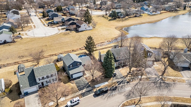 drone / aerial view with a residential view and a water view