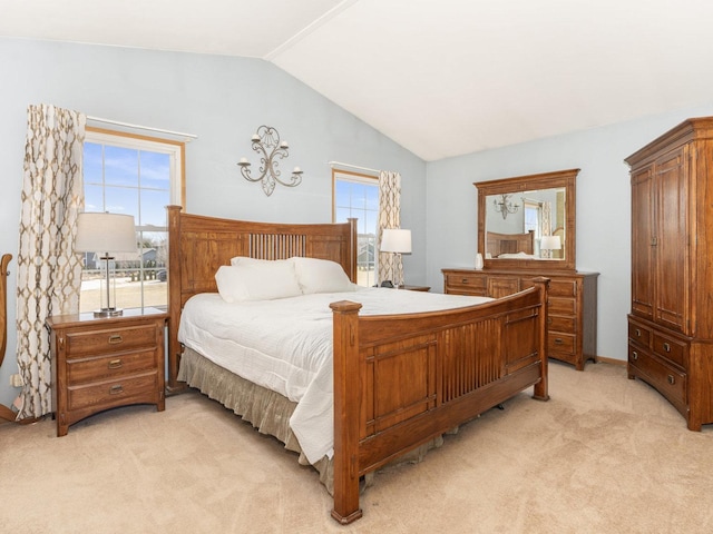 bedroom with lofted ceiling and light carpet