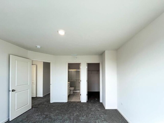 half bathroom with vanity, tile patterned floors, and toilet