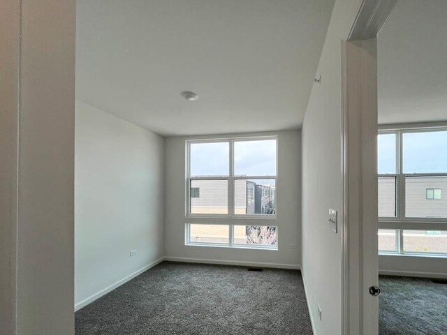 living area featuring visible vents, baseboards, and carpet flooring