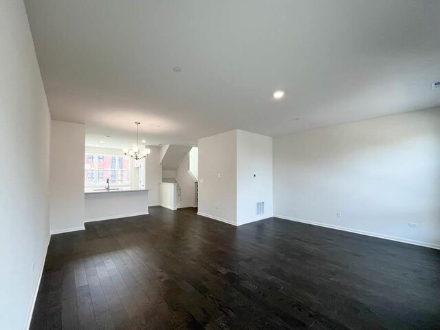 carpeted spare room with visible vents, plenty of natural light, and baseboards