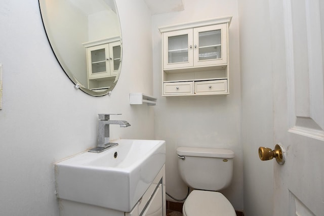 half bath featuring toilet and vanity