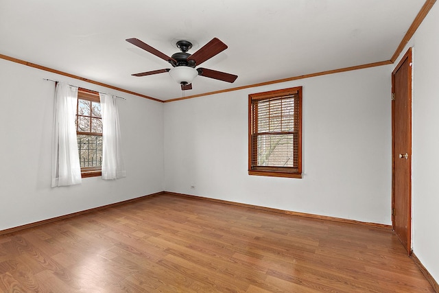 unfurnished room featuring light wood finished floors, baseboards, crown molding, and a ceiling fan