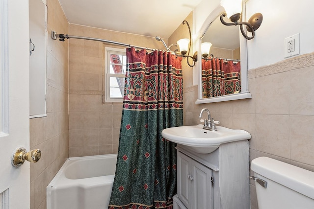 bathroom with shower / bath combo with shower curtain, toilet, tile walls, and vanity