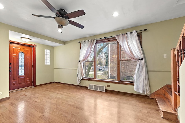 foyer with visible vents, baseboards, wood finished floors, and a ceiling fan