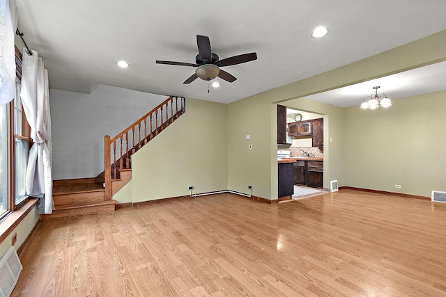 unfurnished living room featuring visible vents, stairs, and light wood-type flooring