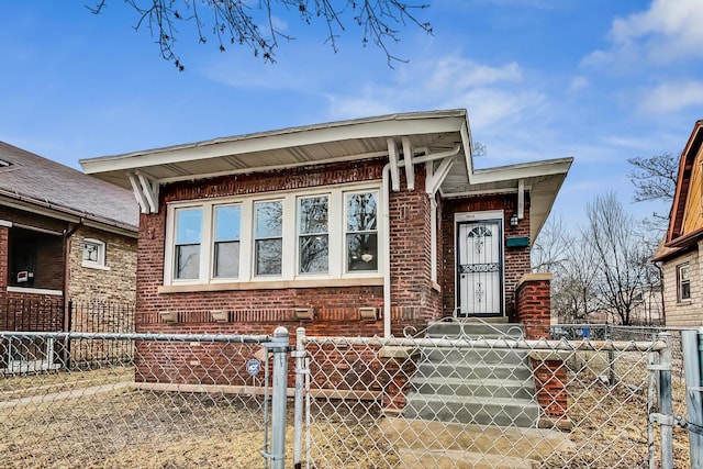 view of front of house featuring brick siding and fence