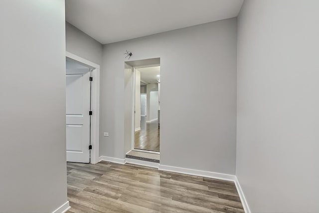 unfurnished room featuring wood finished floors and baseboards