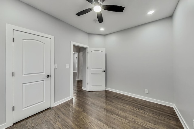 unfurnished bedroom with recessed lighting, baseboards, and dark wood-style flooring