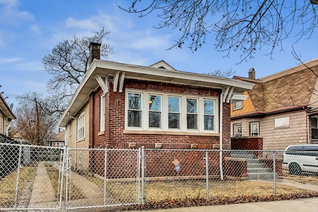 view of side of home featuring a fenced front yard, brick siding, and a chimney