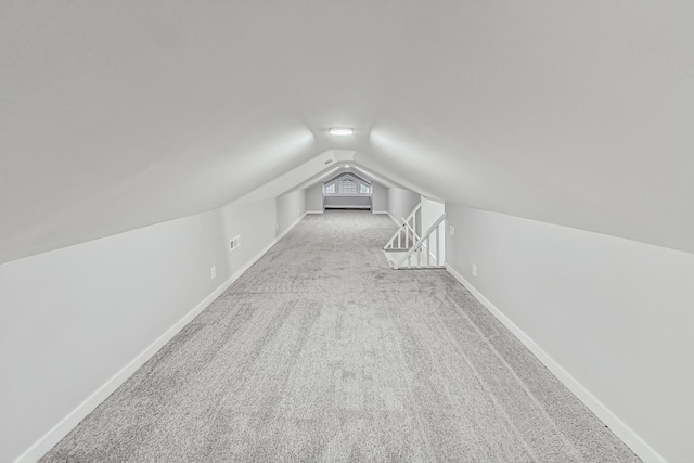 bonus room with baseboards, carpet floors, and vaulted ceiling