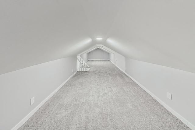 bonus room featuring vaulted ceiling, baseboards, and carpet floors