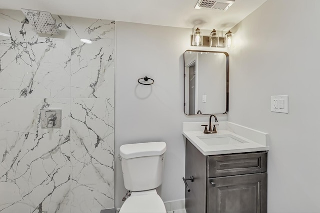 bathroom with a marble finish shower, visible vents, toilet, and vanity