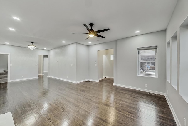 empty room featuring dark wood finished floors, stairway, and recessed lighting