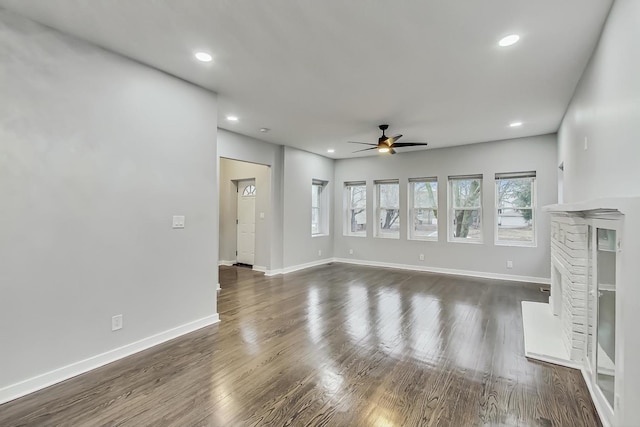 unfurnished living room featuring recessed lighting, baseboards, ceiling fan, and dark wood-style flooring