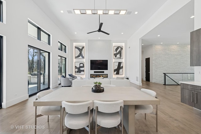 dining area with ceiling fan, light wood finished floors, and recessed lighting