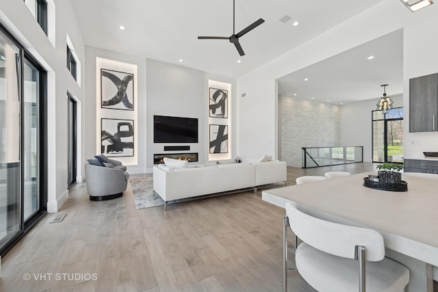 living room with visible vents, light wood-type flooring, recessed lighting, and a ceiling fan