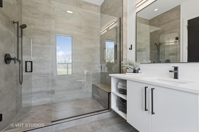 bathroom with a shower stall, tile patterned floors, and vanity