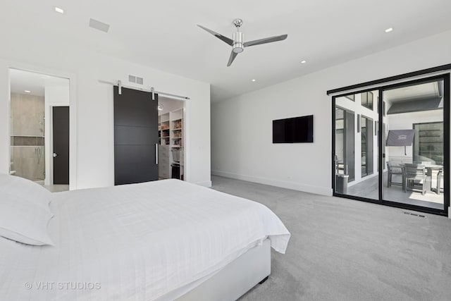 bedroom featuring visible vents, a barn door, access to exterior, carpet flooring, and baseboards