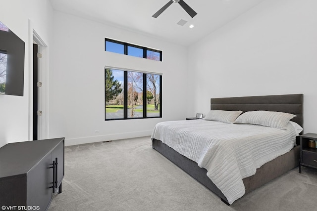 carpeted bedroom featuring high vaulted ceiling, ceiling fan, and baseboards