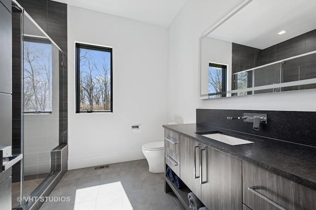 full bathroom with visible vents, toilet, a stall shower, and vanity