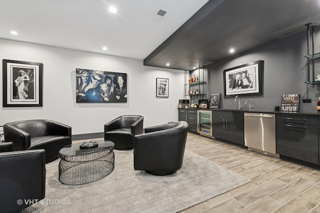 bar featuring dishwasher, indoor wet bar, wine cooler, recessed lighting, and light wood finished floors