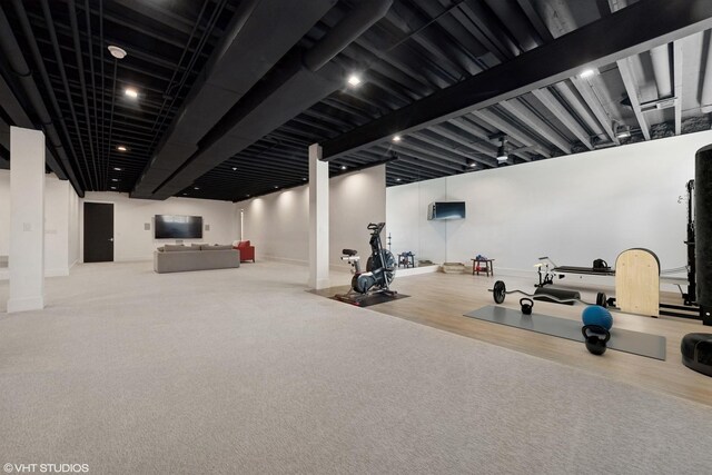 exercise area featuring baseboards and carpet flooring