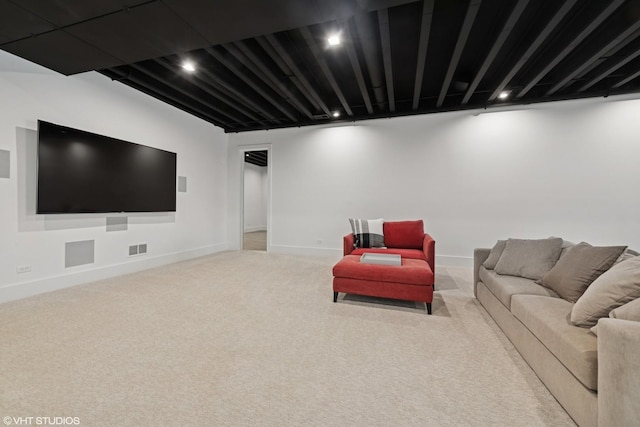 carpeted living area with recessed lighting, visible vents, and baseboards