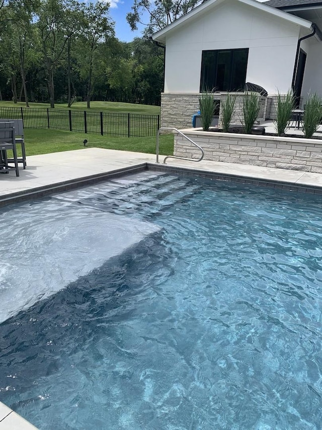 view of swimming pool with a patio area, fence, a fenced in pool, and a lawn