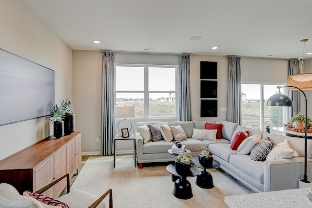 living room with recessed lighting and baseboards