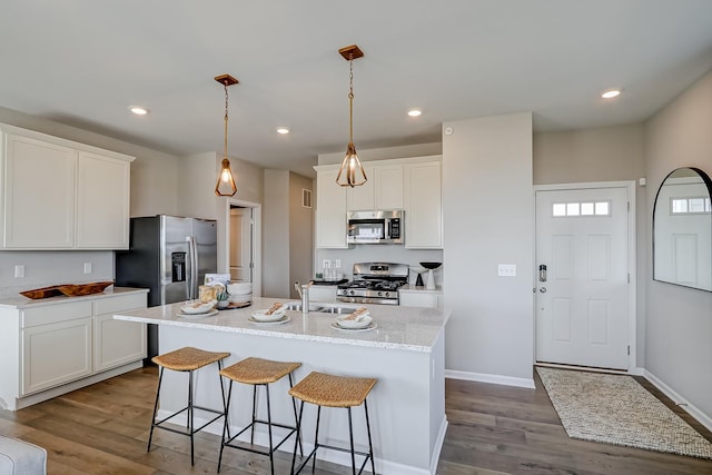 kitchen featuring recessed lighting, appliances with stainless steel finishes, white cabinets, and dark wood-style flooring