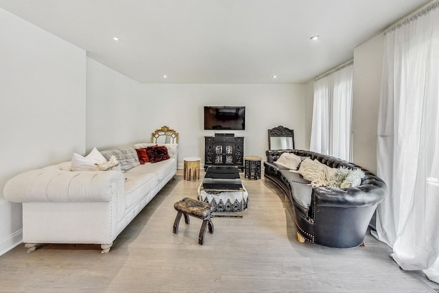 living room with recessed lighting and light wood-style floors