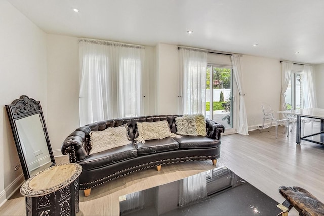 living room featuring recessed lighting, baseboards, and wood finished floors